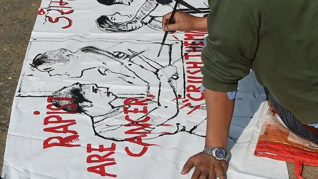 Indian artists work on a banner condemning rape in New Delhi on December 16, 2014, the second second anniversary of the fatal gang-rape of a student in the Delhi