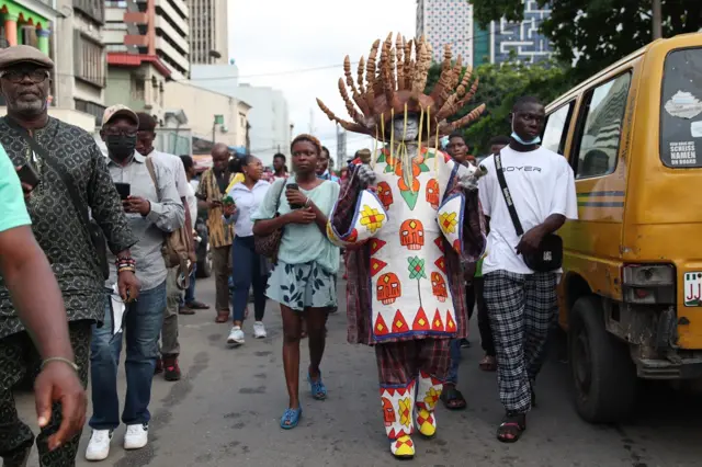 Nigerian performance artist Jelili Atiku (2-R) performs along a street at the Lagos Book and Art Festival at the Freedom park in central Lagos, Nigeria 16 October 2021