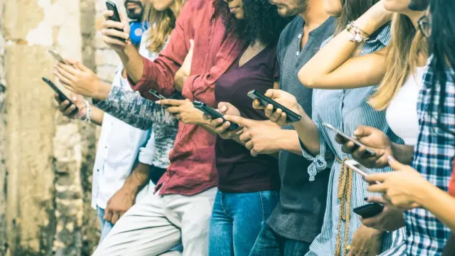 Pessoas com celularesjogadas da roletamãos