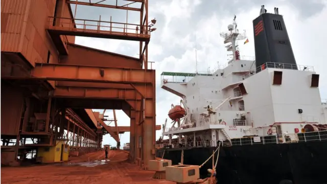 Un cargo est chargé de bauxite dans l'usine de bauxite de la plus grande entreprise minière de Guinée, la Compagnie des Bauxites de Guinée (CBG), à Kamsar, une ville située au nord de la capitale Conakry