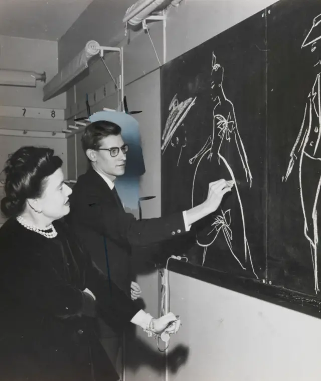 Yves Saint Laurent desenhando modelos no quadro-negrojogar paciência grátis online1957, ao ladojogar paciência grátis onlineMadame Marguerite Carré, chefe das oficinas da Dior