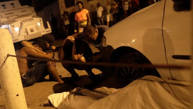 Personas lamentando la muerte de Jean Rodrigo