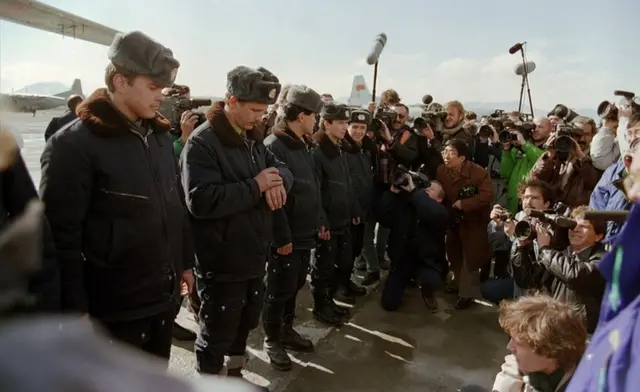 Red Army soldiers surrounded by foreign press wait at Kabul airport in February 1989, during the Soviet Army's withdrawal from Afghanistan.