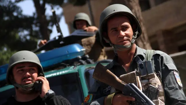 Afghan security officials patrol after they took back control of parts of Herat city