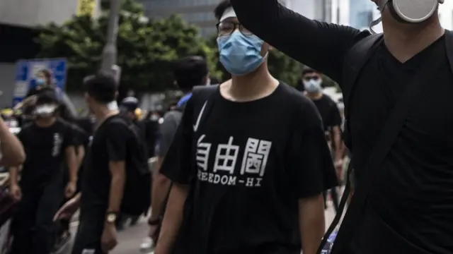 A protester makes a gesture outside the government headquarters and the police headquarters during a demonstration in Hong Kong.