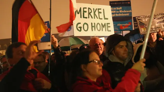 Supporters of the AfD political party protest against German Chancellor Angela Merkel's liberal policy towards taking in migrants and refugees