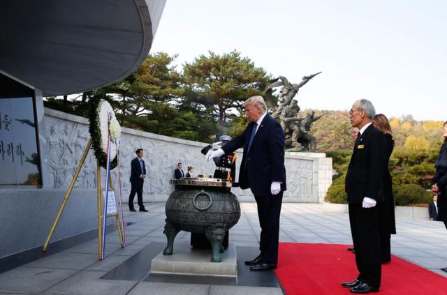U.S. President Donald Trump burns incense at the National Cemetery on November 8, 2017 in Seoul, South Korea. Trump is in South Korea as a part of his Asian tour. (Photo by Jeon Heon-Kyun-Pool/Getty Images)