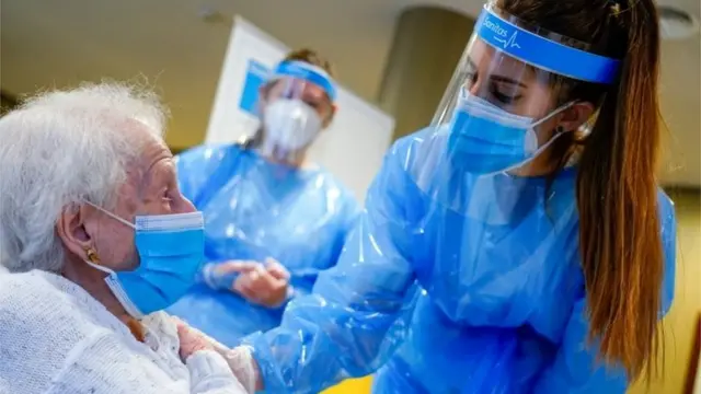 Una anciana siendo vacunada en España