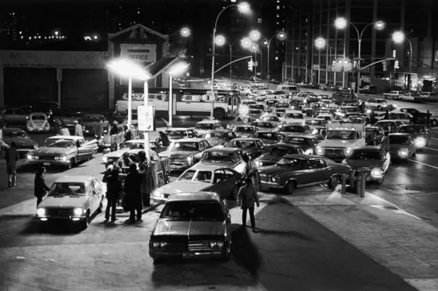 A long line of cars lined up for gas at filling station on a Saturday night during the oil crisis of 1973, Brooklyn, New York City