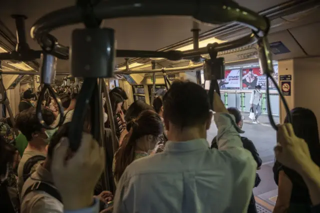 Commuters ride a Bangkok Mass Transit System (BTS) train in Bangkok, 