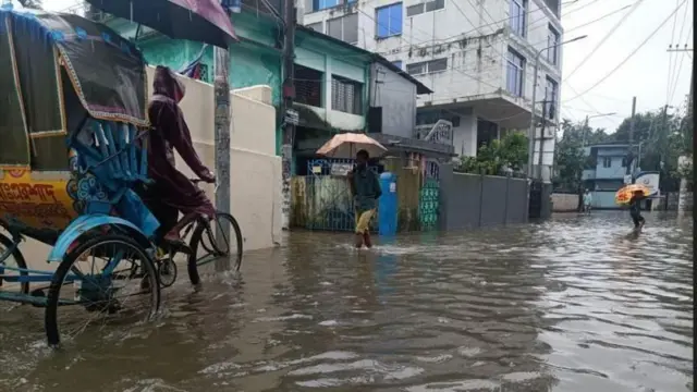 The rickshaw is running on the flooded road