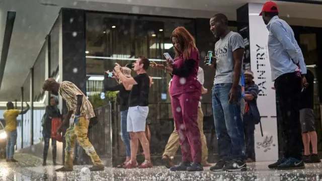 On Sunday, people take shelter during a hailstorm in Windhoek, Namibia.