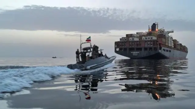 زورق يقترب من سفينة في مضيق هرمز .