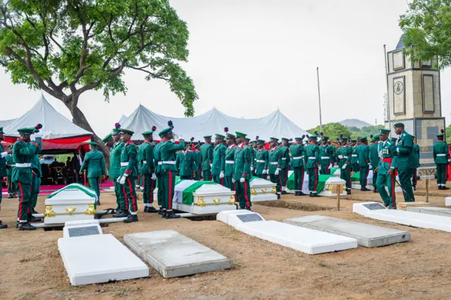 An assembly of Nigerian troop standing caskets of some fallen soldiers