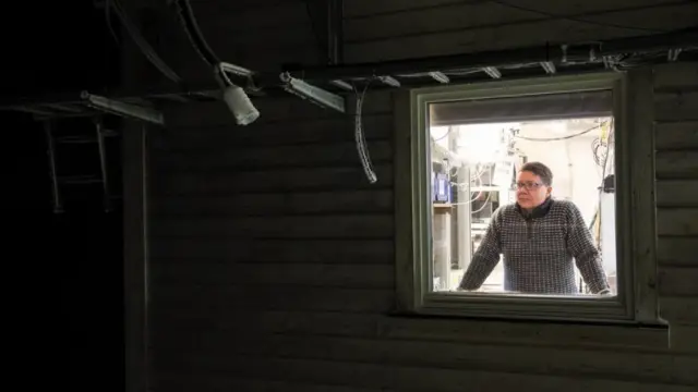 Ove Hermansen looks through window