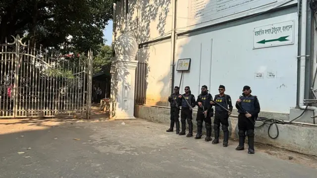 আন্তর্জাতিক অপরাধ ট্রাইব্যুনালের গেটের সামনে অস্ত্র হাতে দাঁড়িয়ে আছেন র‍্যাবের পাঁচজন সদস্য