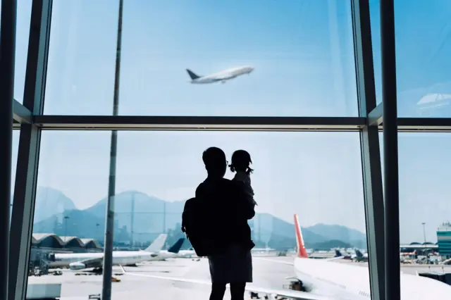 a father and a daughter in an airport.