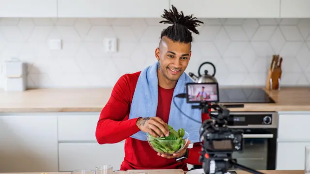 Fitness vlogger making a video of himself at home