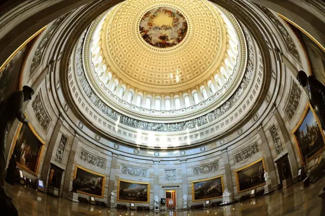 The Capitol Rotunda, pictured, is a large gilded and frescoed dome surrounded by marble walls