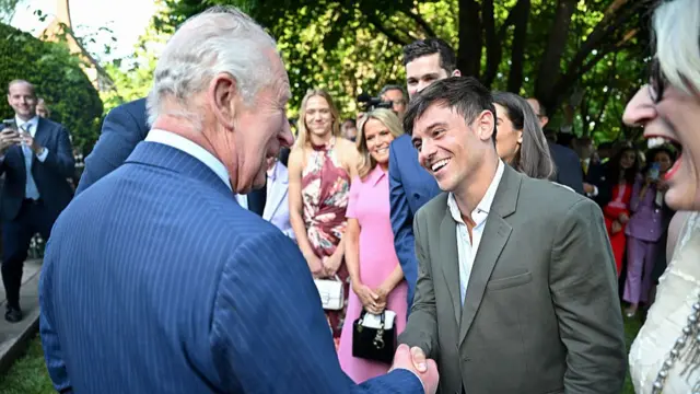 King Charles III chats with British diver Tom Daley