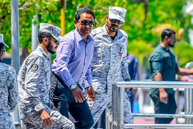 Former Maldives' president Abdulla Yameen (C) looks on as he is escorted to board a speedboat of Correctional Service heading back to prison, after the High Court ruling, in Male on February 6, 2020. - The Maldives High Court ruled on February 6 against the suspension of sentence and release on bail of ex-president Abdulla Yameen, who was sentenced to five years in prison for money laundering on November 28, 2019.