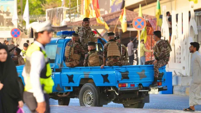 آلية زرقاء تحمل جنوداً عراقيين في النجف