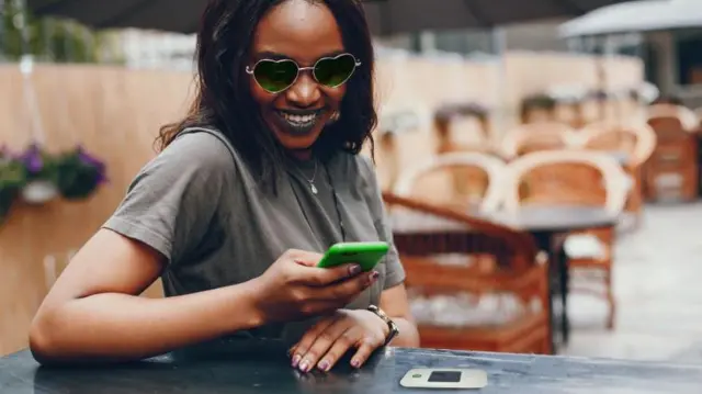 Aworan obinrin to mu foonu lọwọ