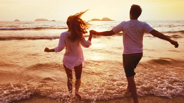 Couple entering the sea