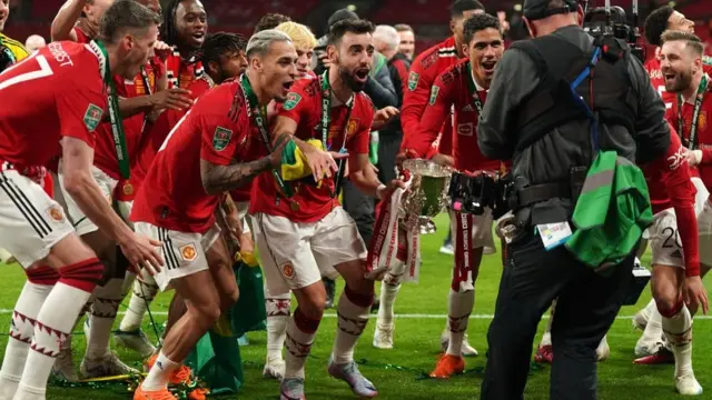 Manchester United's players celebrate after defeating Newcastle United in the Carabao Cup final at Wembley