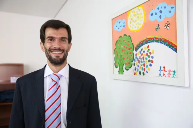 Iberê Dias, Juiz Assessor da Corregedoria Geral da Justiçaquina pela internetSP, aparece na imagem com uma pintura infantilquina pela internetquadro, na parede