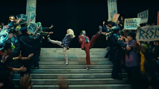 Lady Gaga y Joaquin Phoenix bailando en las escaleras de una sala de tribunal en 