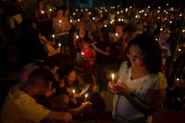 People pray outside the Brumadinho Matriz Church