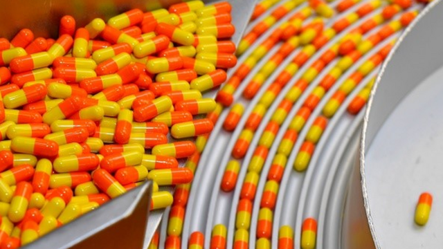 Cápsulas amarelas e laranjas organizadas dentrogiga sena quinauma máquina
