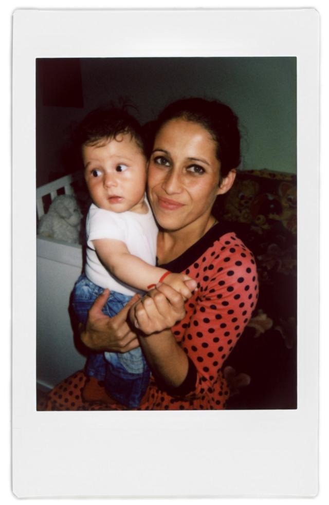 A polaroid photo of Ratha and her baby