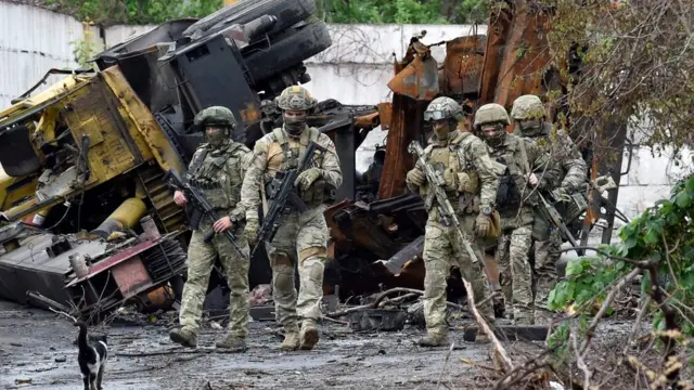 Russian servicemen patrol the destroyed part of the Ilyich Iron and Steel Works in Ukraine's port city of Mariupol on May 18, 2022, amid the ongoing Russian military action in Ukraine