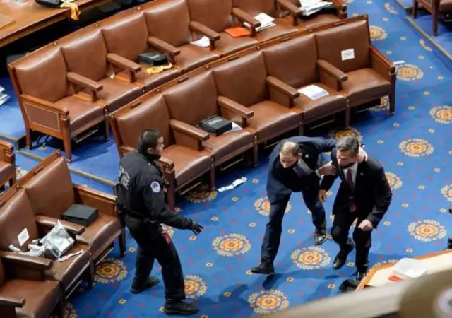 Members of Congress take cover as protesters enta