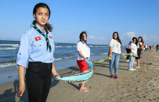 Tunisians form a human chain along the beaches in the southern suburbs near Tunis.