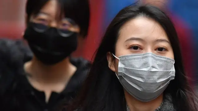 Pedestrians wear surgical masks in London's China Town on January 24, 2020