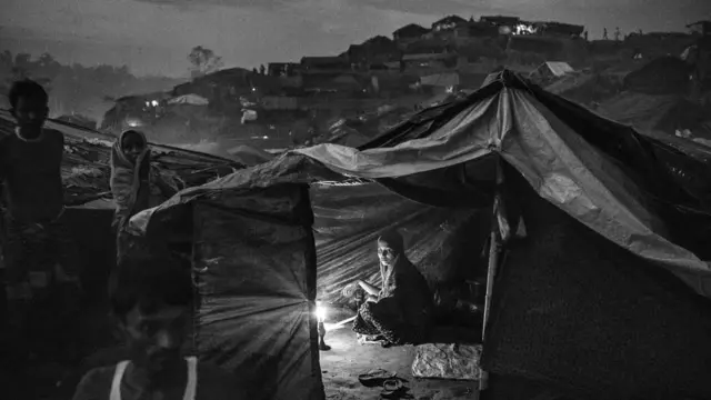 Rohingya woman sits in a tent in a refugee camp near Cox's Bazaar