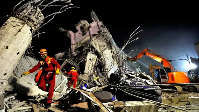 Rescuers remove debris as they continue to search for survivors from a collapsed building following a 6.4 magnitude earthquake struck the area in Tainan City, south Taiwan, Taiwan, 06 February
