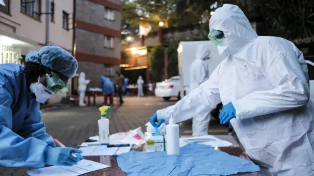 Doctors prepare to administer the mandatory Covid-19 coronavirus test for detainees of a government designated quarantine facility in Nairobi