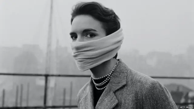 ਸਾਲ 1950 ਵਿੱਚ ਮਾਸਕ ਪਹਿਨੇ ਇੱਕ ਔਰਤ