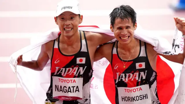 Japan's Tadashi Horikoshi (right) celebrates after crossing the line in third place to take the bronze medal in the Men's Marathon T12 alongside Japan's Tsutomu Nagata who took the bronze in the Men's Marathon T46 at the Olympic Stadium during day twelve of the Tokyo 2020 Paralympic Games in Japan. Picture date: Sunday September 5, 2021. PA Photo. See PA story PARALYMPICS Athletics. Photo credit should read: Tim Goode/PA Wire.