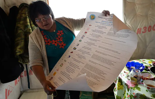 Сотрудница избиркома со списком партий