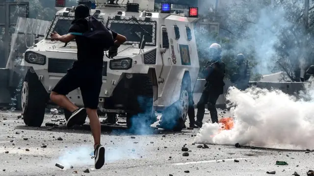 Venezuela'da polis ile çatışan bir gösterici