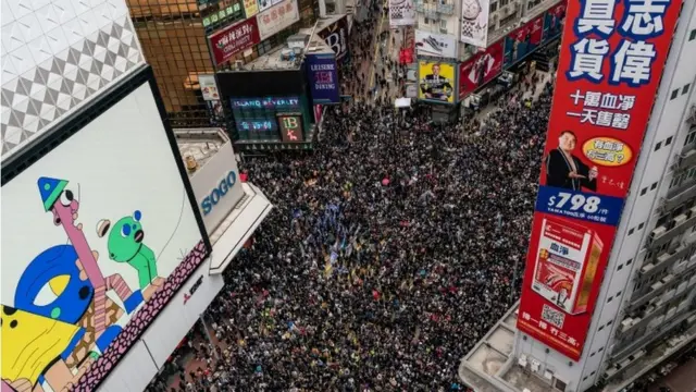 An aerial shot shows thousands of protesters filling a street for a rally on New Year's Day in Hong Kong