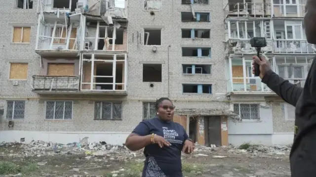 Žena ispred srušene zgrade