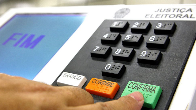 Dedo apertando botão 'confirma'renata fan casas de apostasurna eletrônica