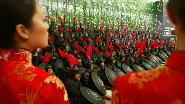A cast of warriors in costumes from the set at a press conference following the premier of Chinese director Zhang Yimou's new film 'Hero', 14 December 2002 in Beijing.