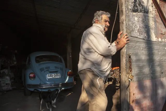 former President of Uruguay José Mujica opens his garage door